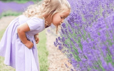 Girl enjoying the aroma of essential oils from flowers
